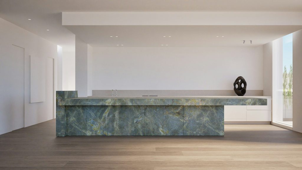 A green marble island standing alone in a pale empty room